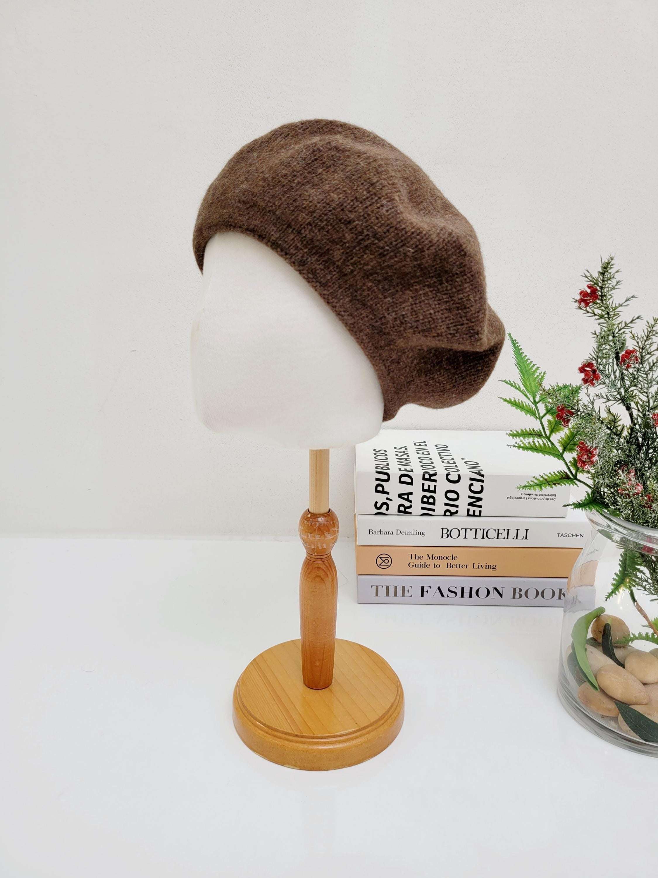 Brown paris wool beret displayed on a mannequin head. A stylish and cozy hat.