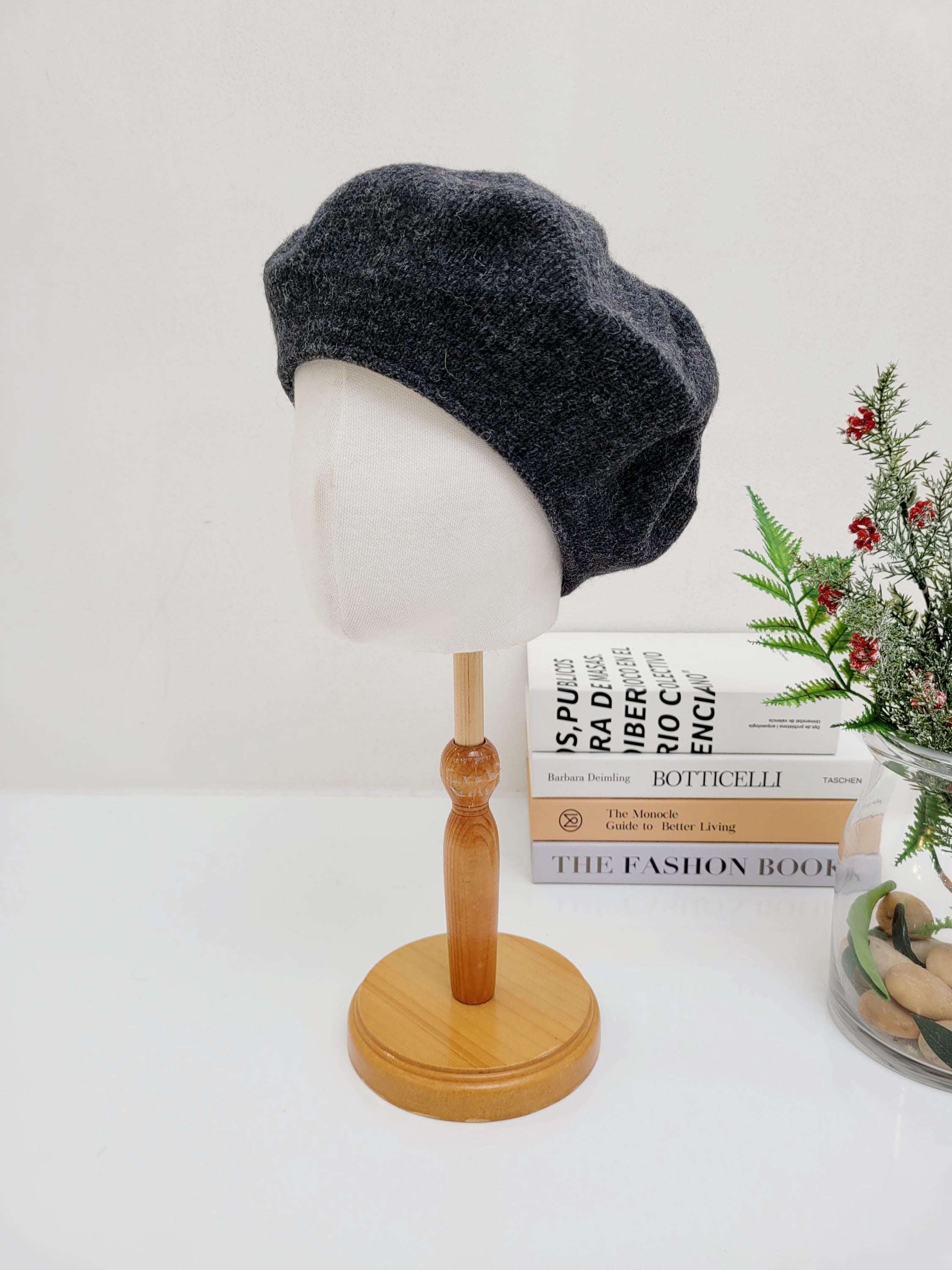 Soft gray paris wool beret displayed on a mannequin, a stylish and classic headwear accessory.