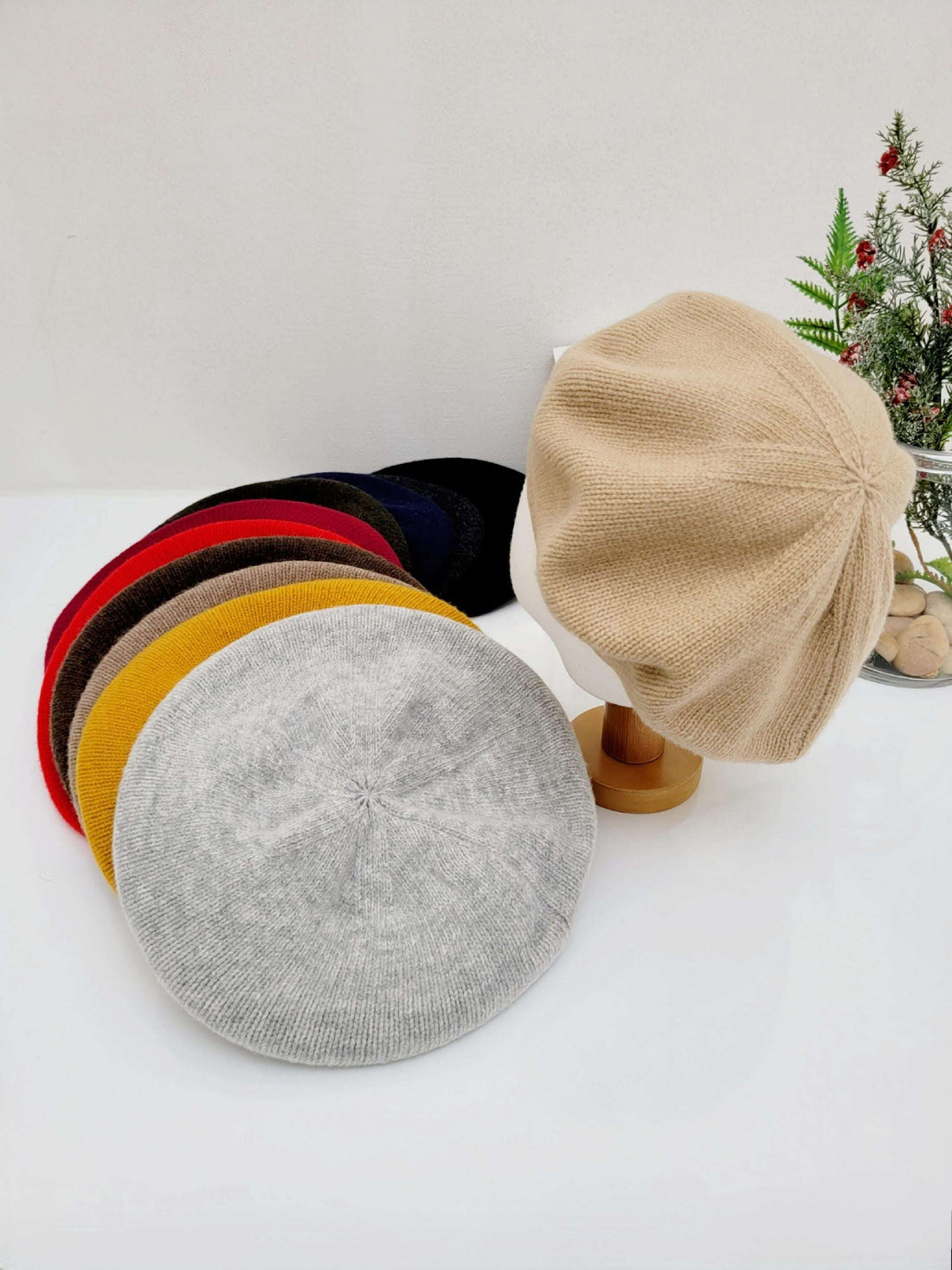 paris wool beret collection: knitted berets in gray, yellow, red, brown, navy, and black, plus beige beret on display.