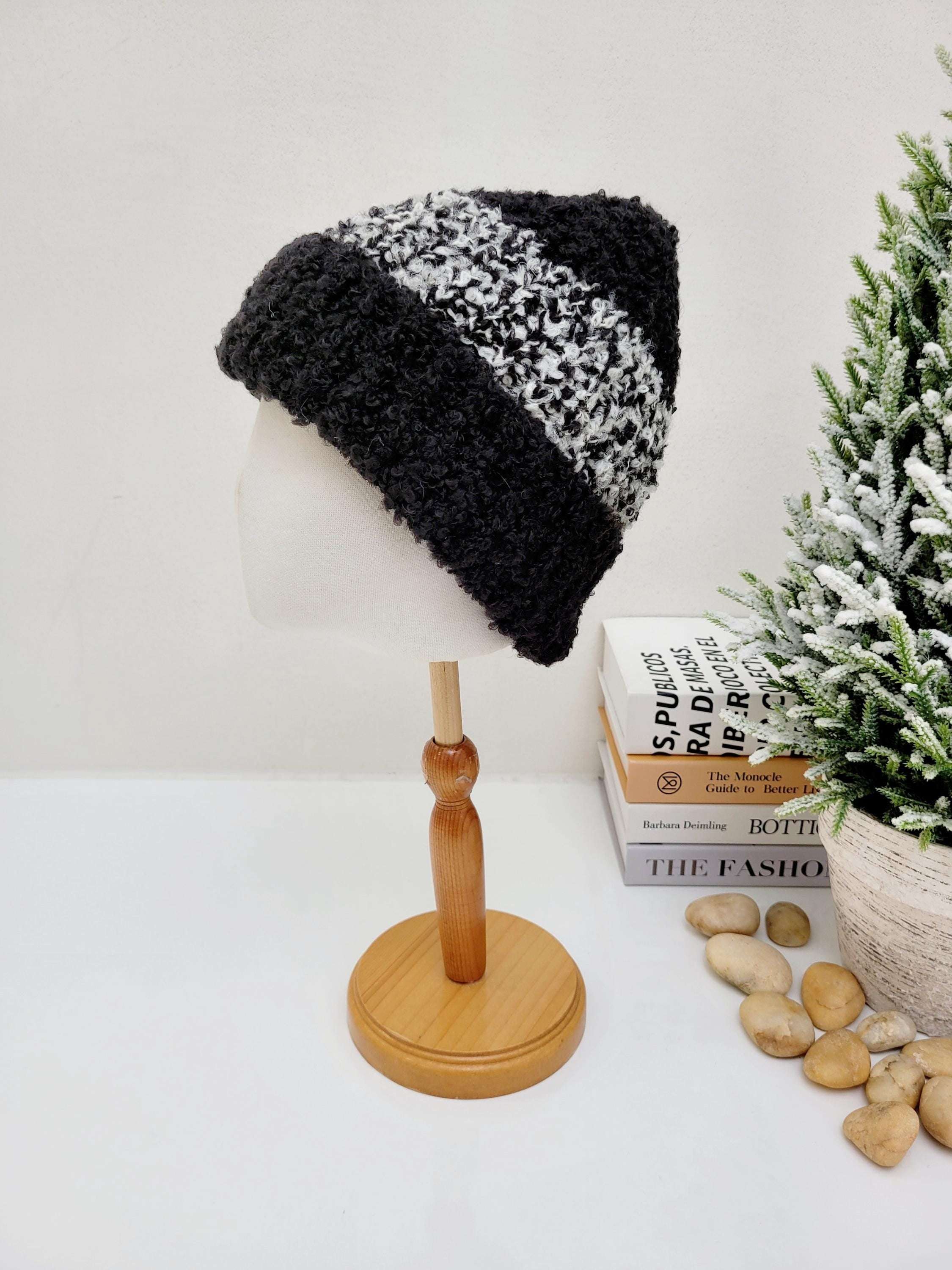 Two-tone tokyo beanie in black and white, textured knit design on a mannequin head. Stylish and warm.