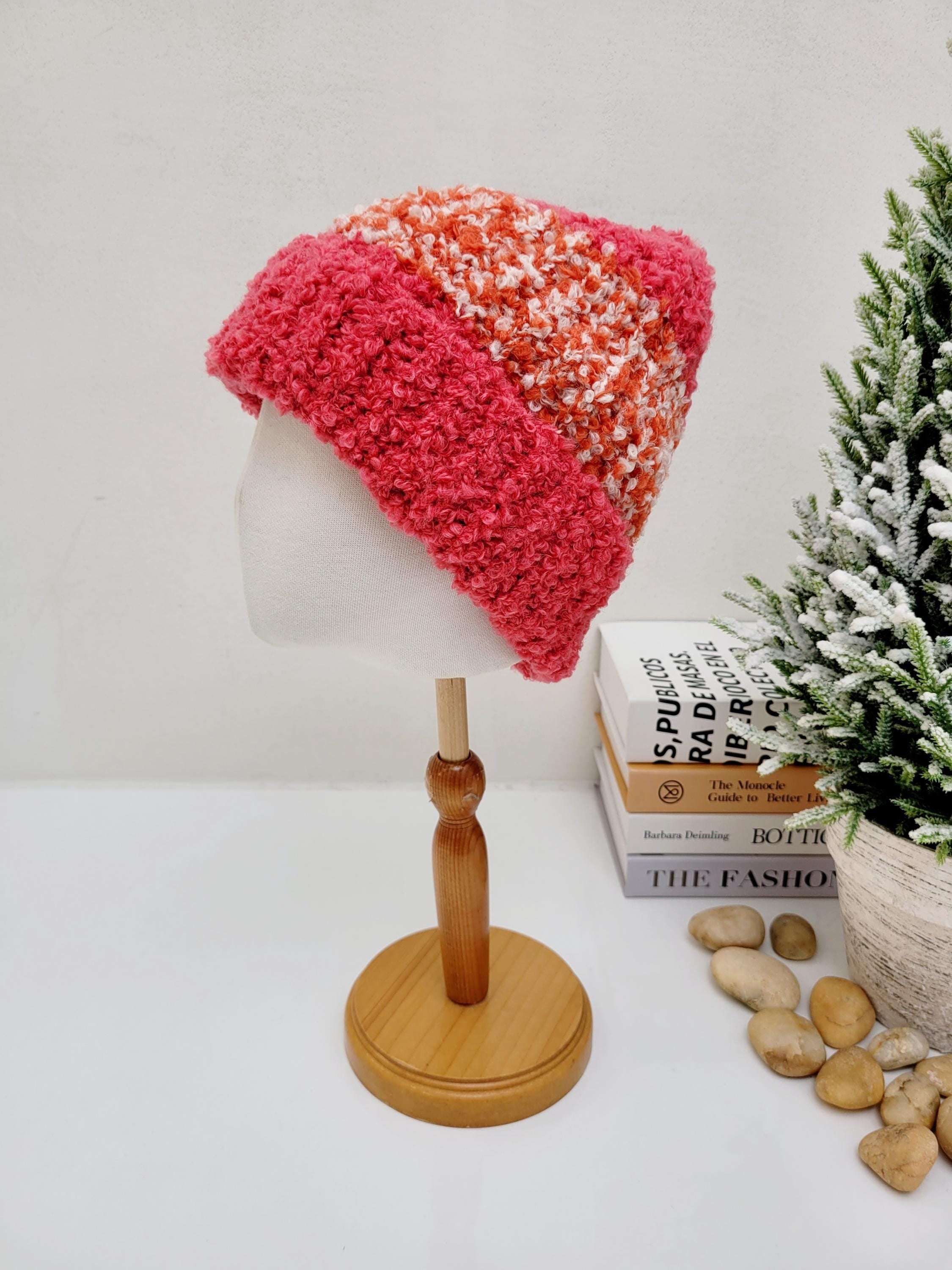 Two-tone tokyo beanie in pink and peach knit, displayed on a mannequin head. Features a textured, cozy design for warmth and style.