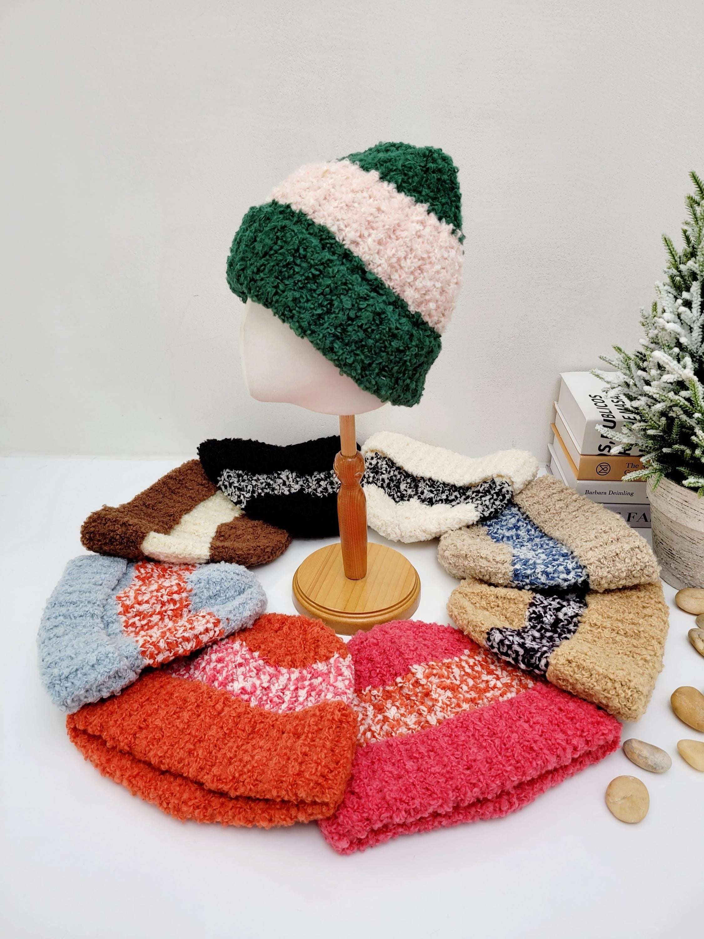 Two-tone knitted tokyo beanie. Display includes green/pink, brown/cream, black/cream, cream/black, tan/blue, blue/coral, orange/cream, and pink/coral color combinations.