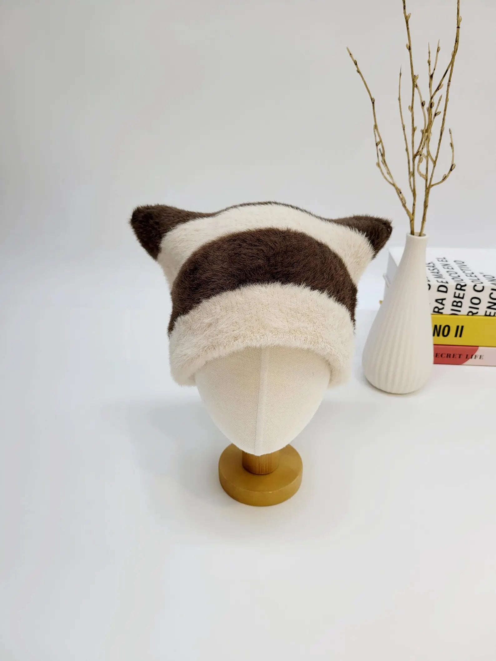 Brown and white striped "cat ear-stripe" hat with soft, fuzzy texture, displayed on a mannequin head.