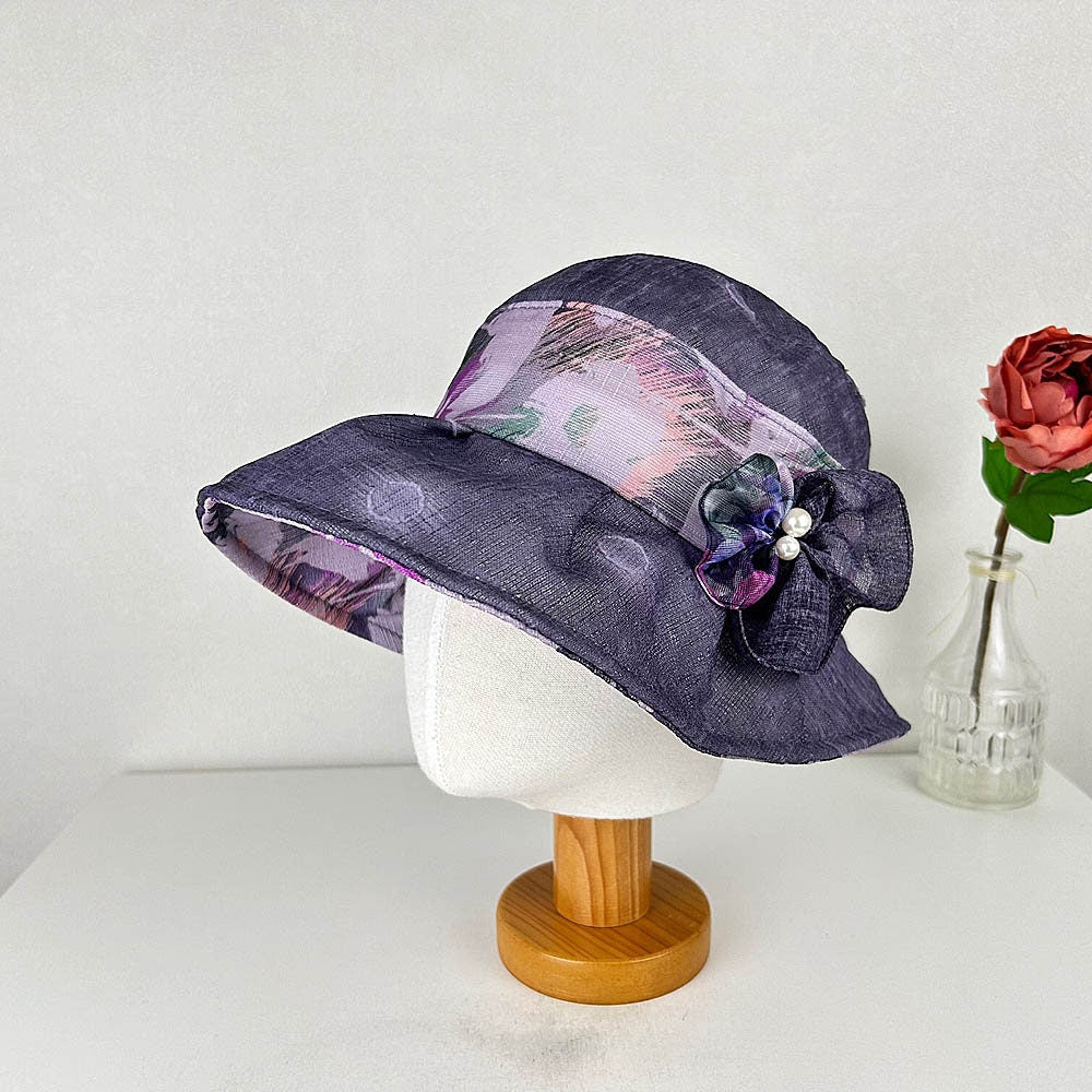 BOTANICAL hat: Purple sun hat with floral band and flower accent on a mannequin head