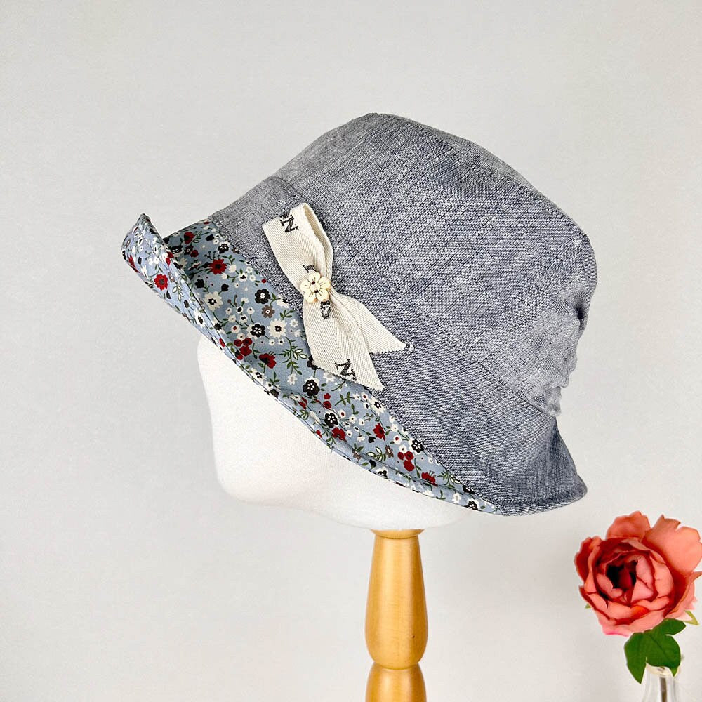 olivia's summer hat: Blue denim-look hat with floral brim and a charming bow detail, perfect for sunny days.