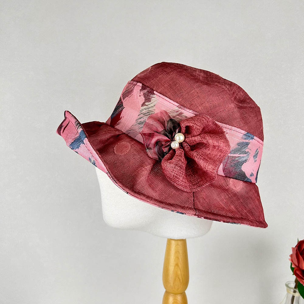 BOTANICAL red floral hat featuring flower accent and pearl details