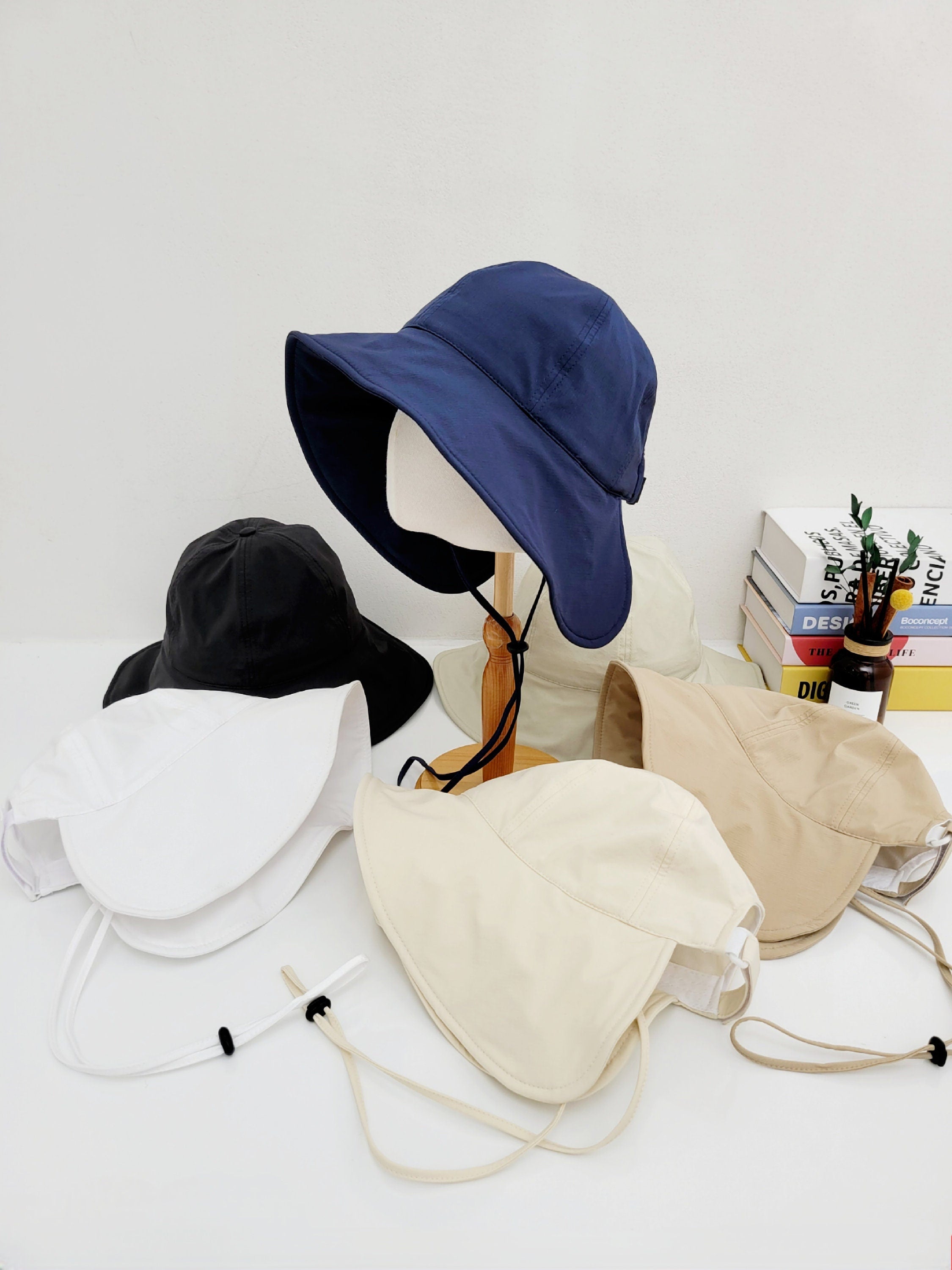 SUMMER LARGE BRIM HAT: Collection of sun hats in navy, black, white, beige, and tan colors.
