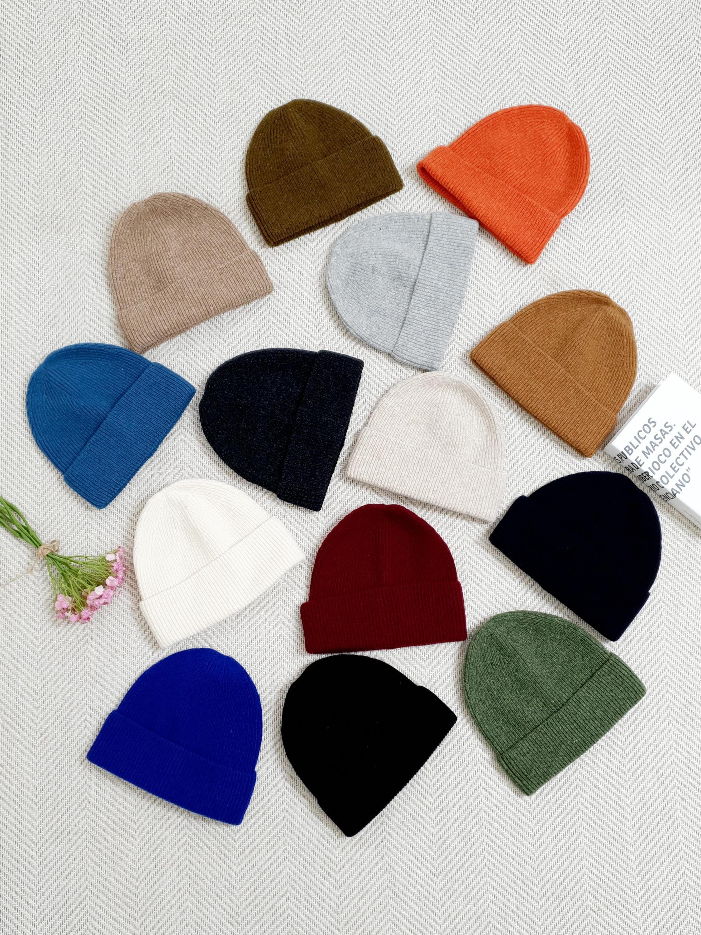 BEANIE THE WOOL: Assorted colorful wool beanies on a textured background.