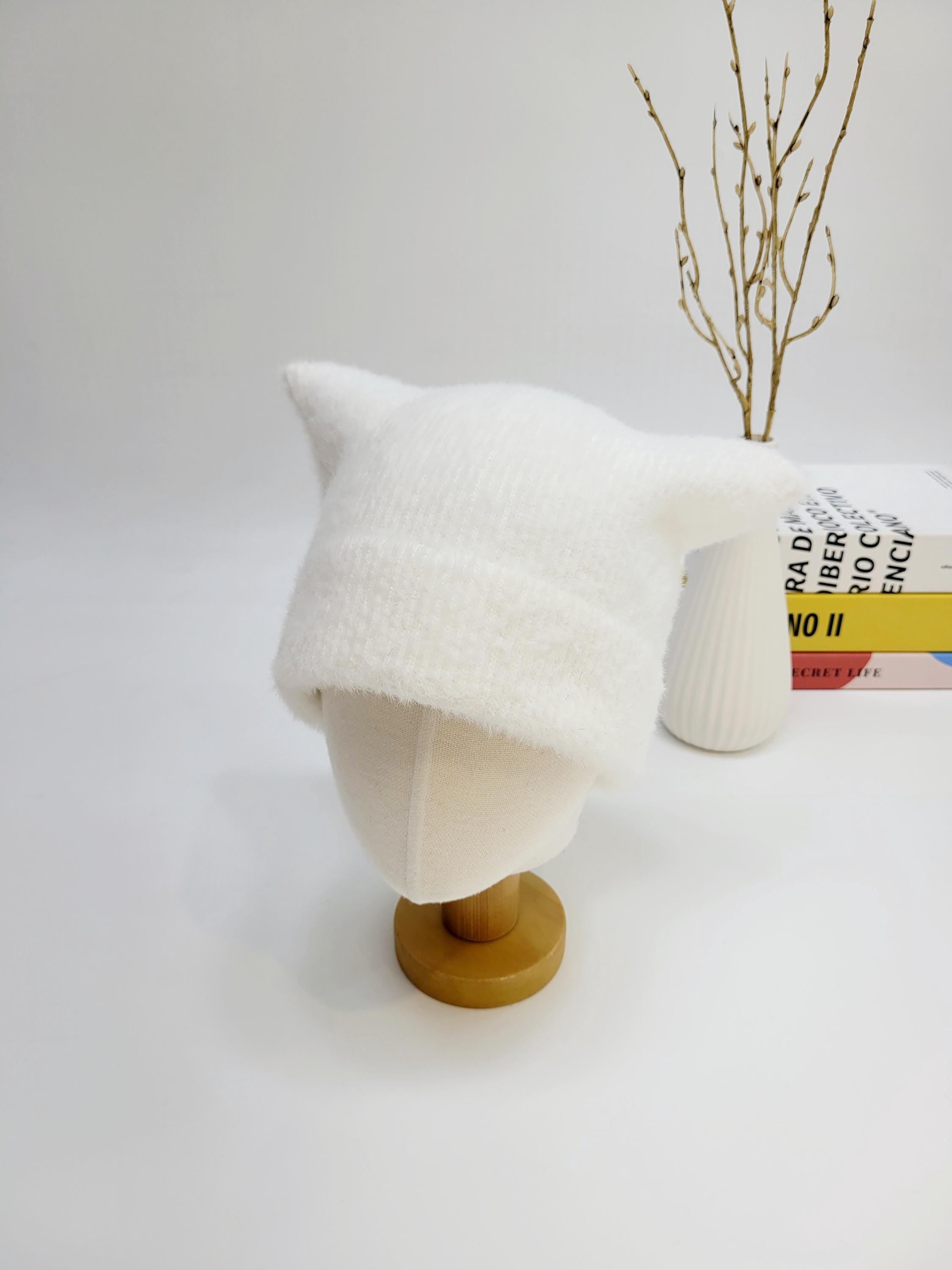 White knit elf in the hat with pointed ears, displayed on a mannequin head.