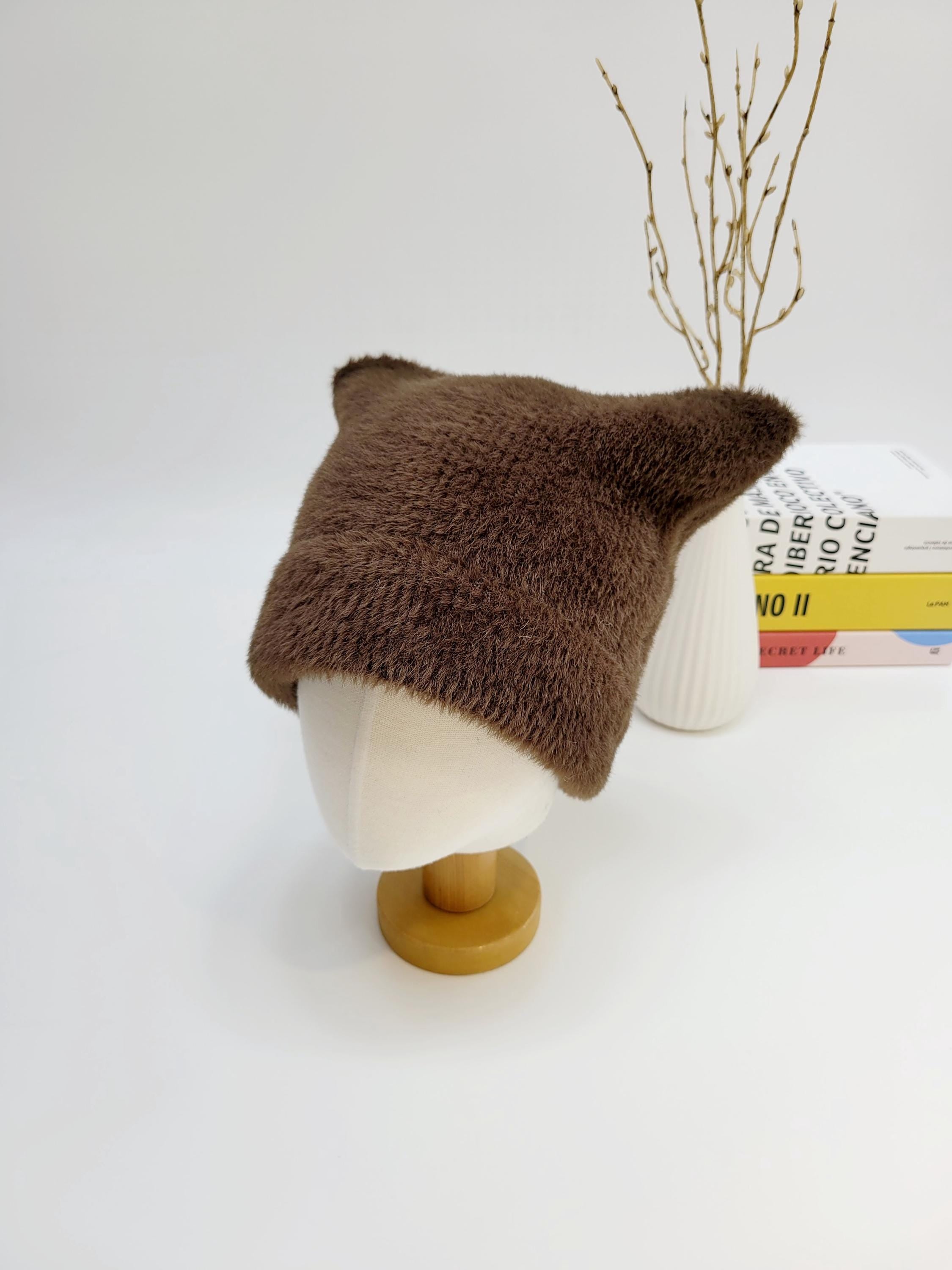 Brown fuzzy elf in the hat with pointy ears, displayed on a mannequin head. A cozy and whimsical accessory.