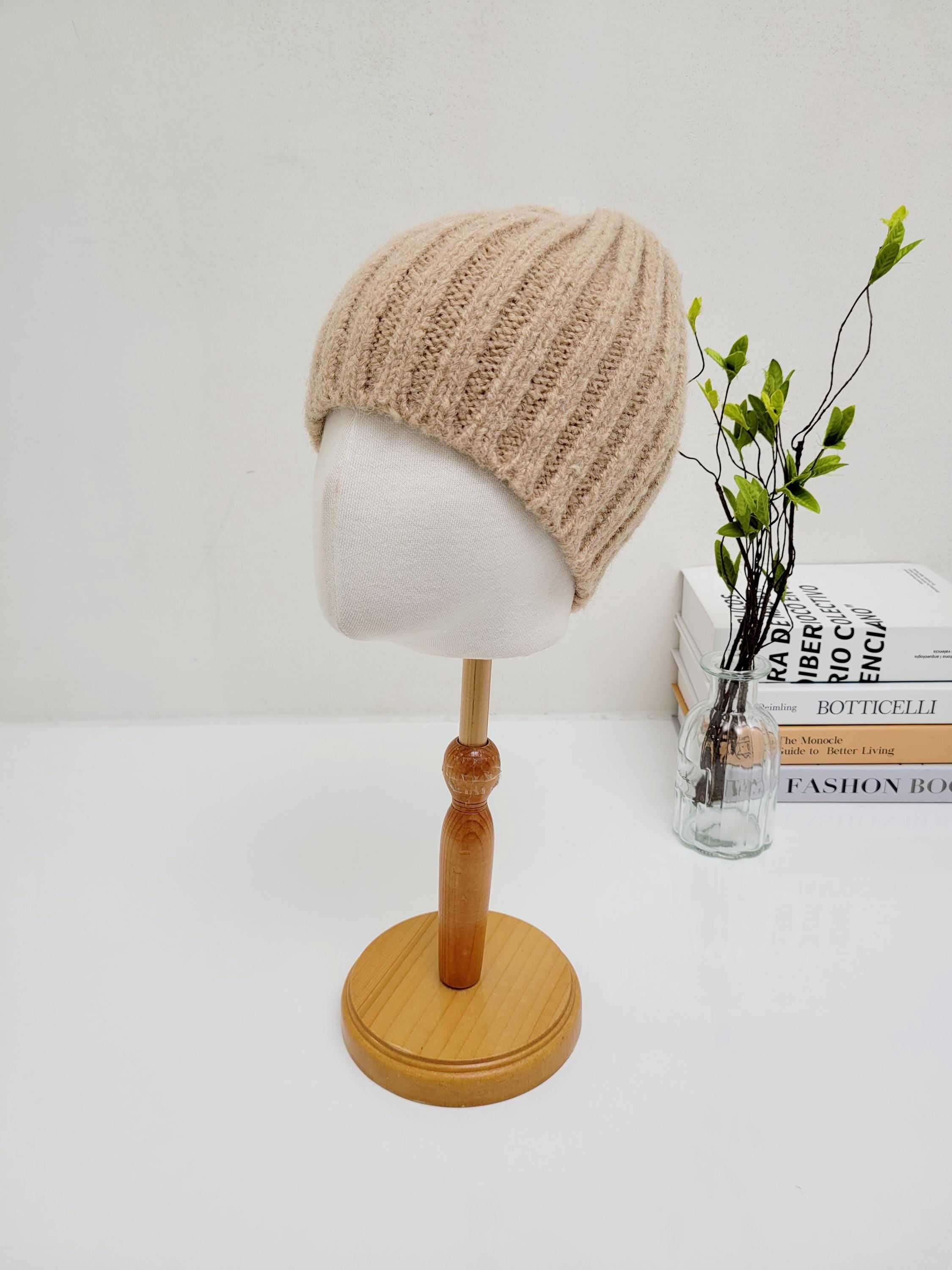 WIDE RIB WOOL BEANIE in soft beige, displayed on a mannequin head. A cozy and stylish knit hat.