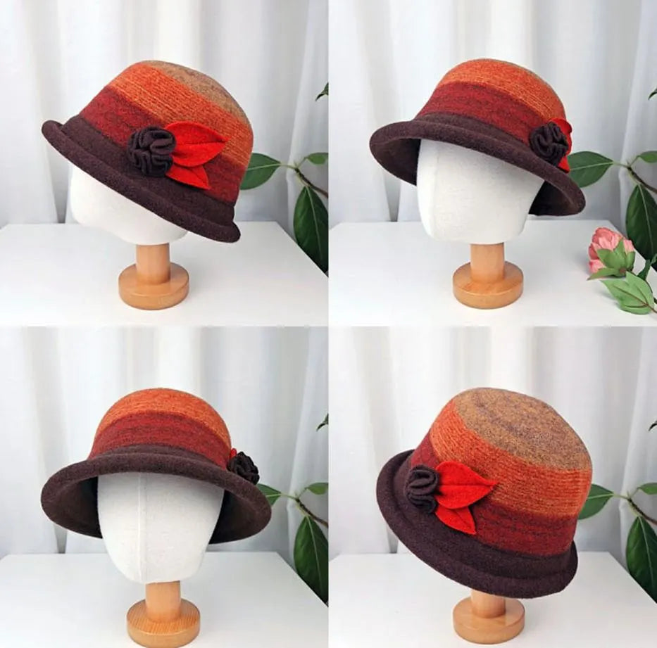 The kelly hat, a brown and orange striped bucket hat with flower detail, displayed on a mannequin head.