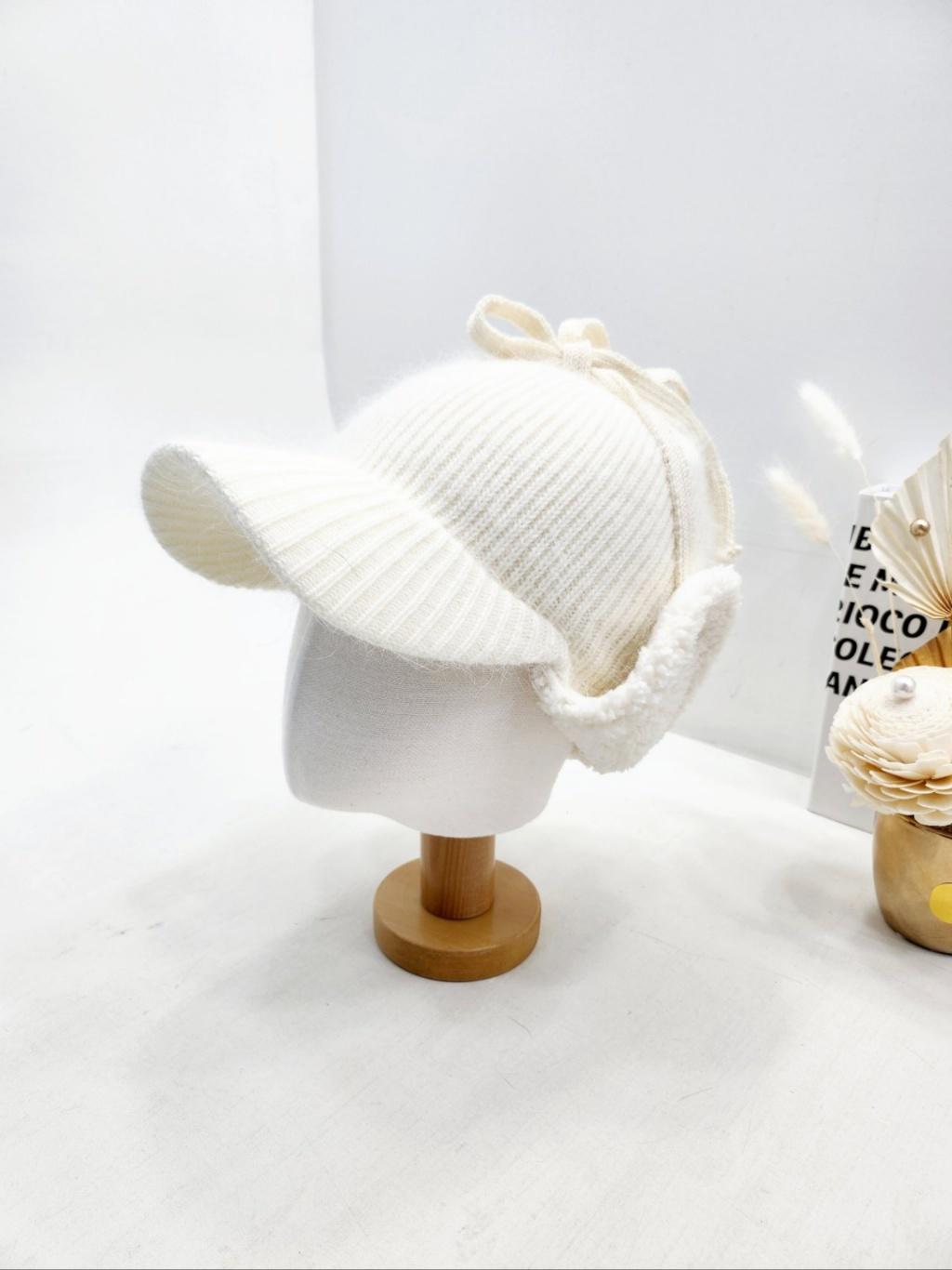 Creamy white angora trapper - earflap hat. Soft knit with cozy ear flaps and a sweet bow detail, perfect for winter warmth.