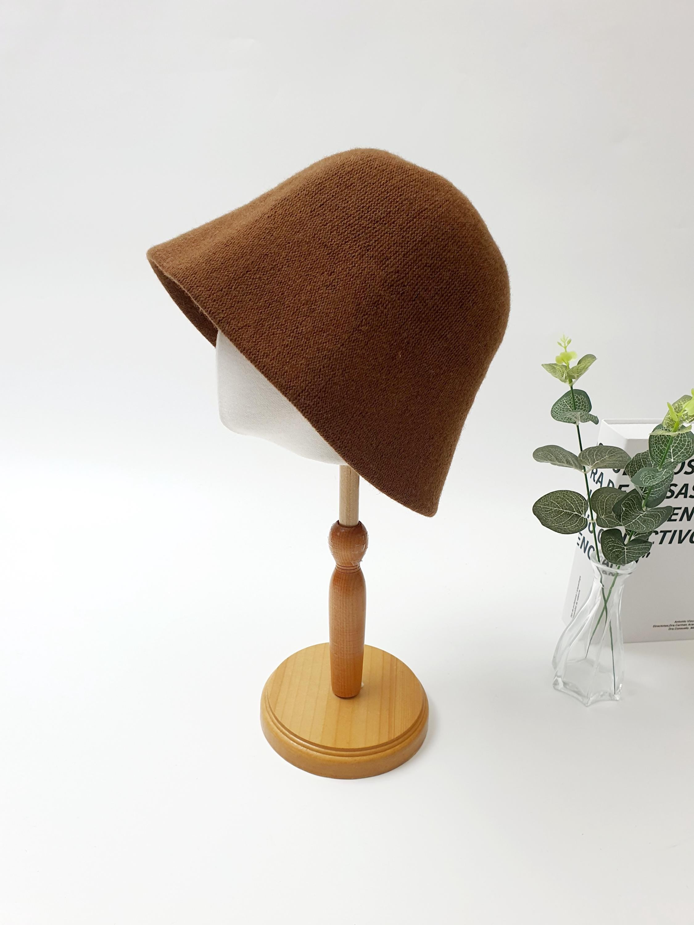 Brown bucket hat, part of the fall'in winter collection, displayed on a mannequin head, perfect for cool weather