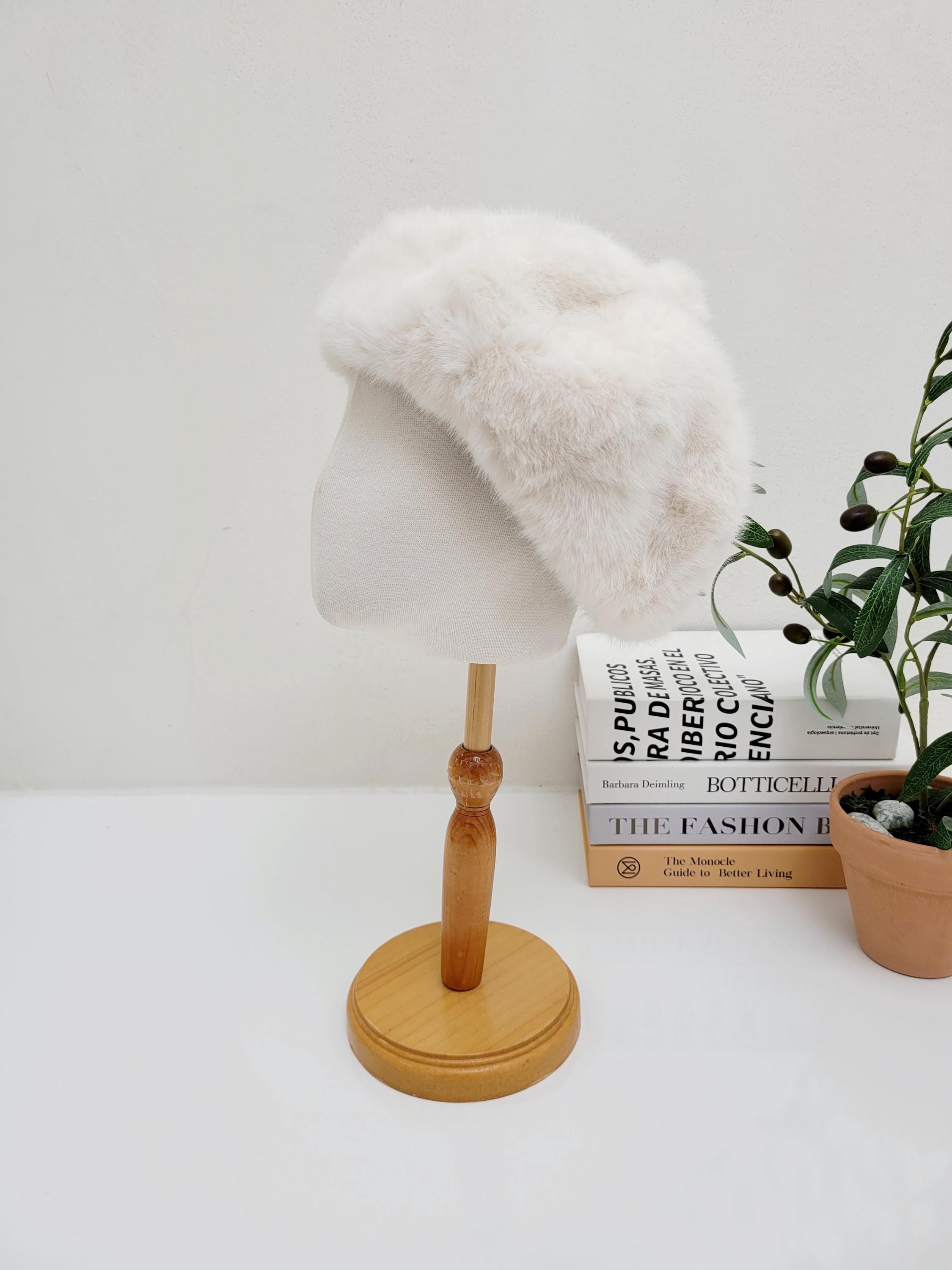 paris in winter faux fur beret, a soft, plush white winter hat for women, displayed on a mannequin head.