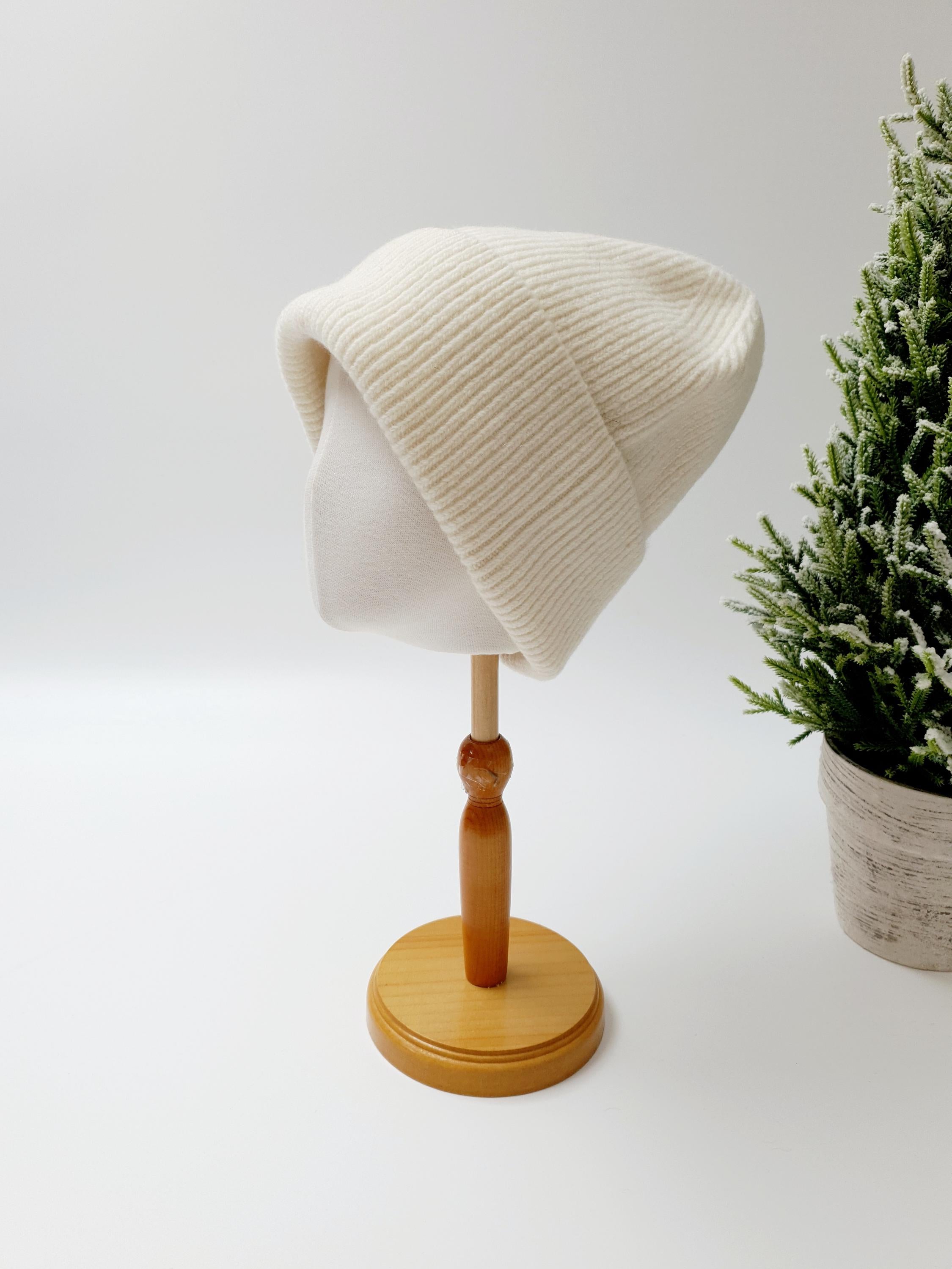 BEANIE THE WOOL: Creamy white wool beanie hat on mannequin head.