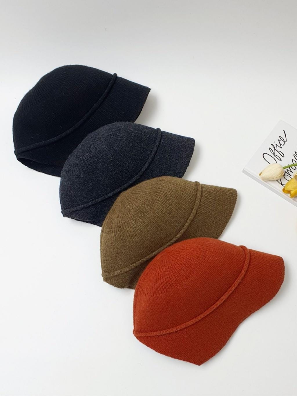 BLAIR knitted hat in black, grey, brown, and orange. Warm winter hat for women with a casual style.