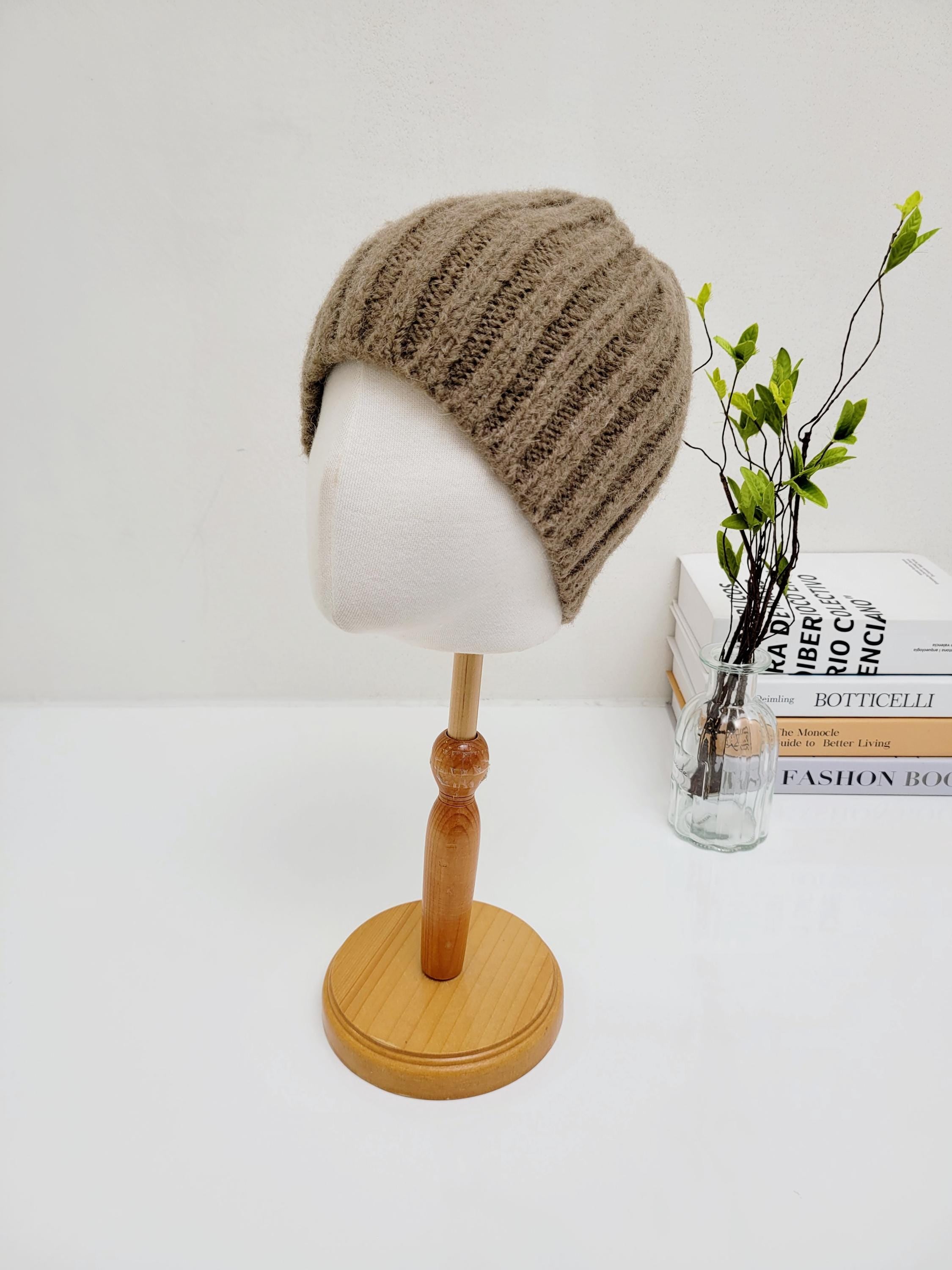 Wide rib wool beanie in soft brown, displayed on a mannequin head. A cozy and stylish winter accessory.