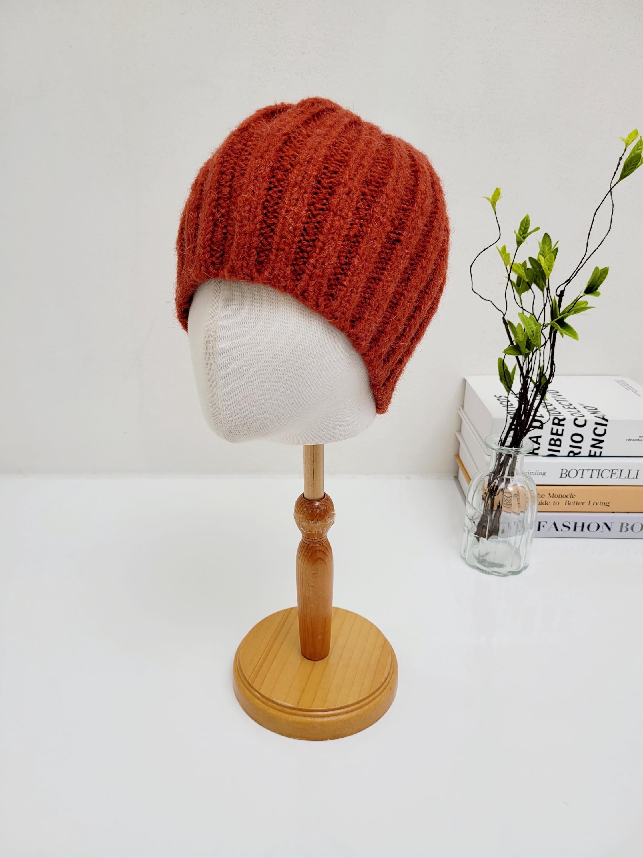 Rust-colored wide rib wool beanie on a mannequin head. Warm and stylish, this wide rib wool beanie is a perfect accessory for cooler weather.