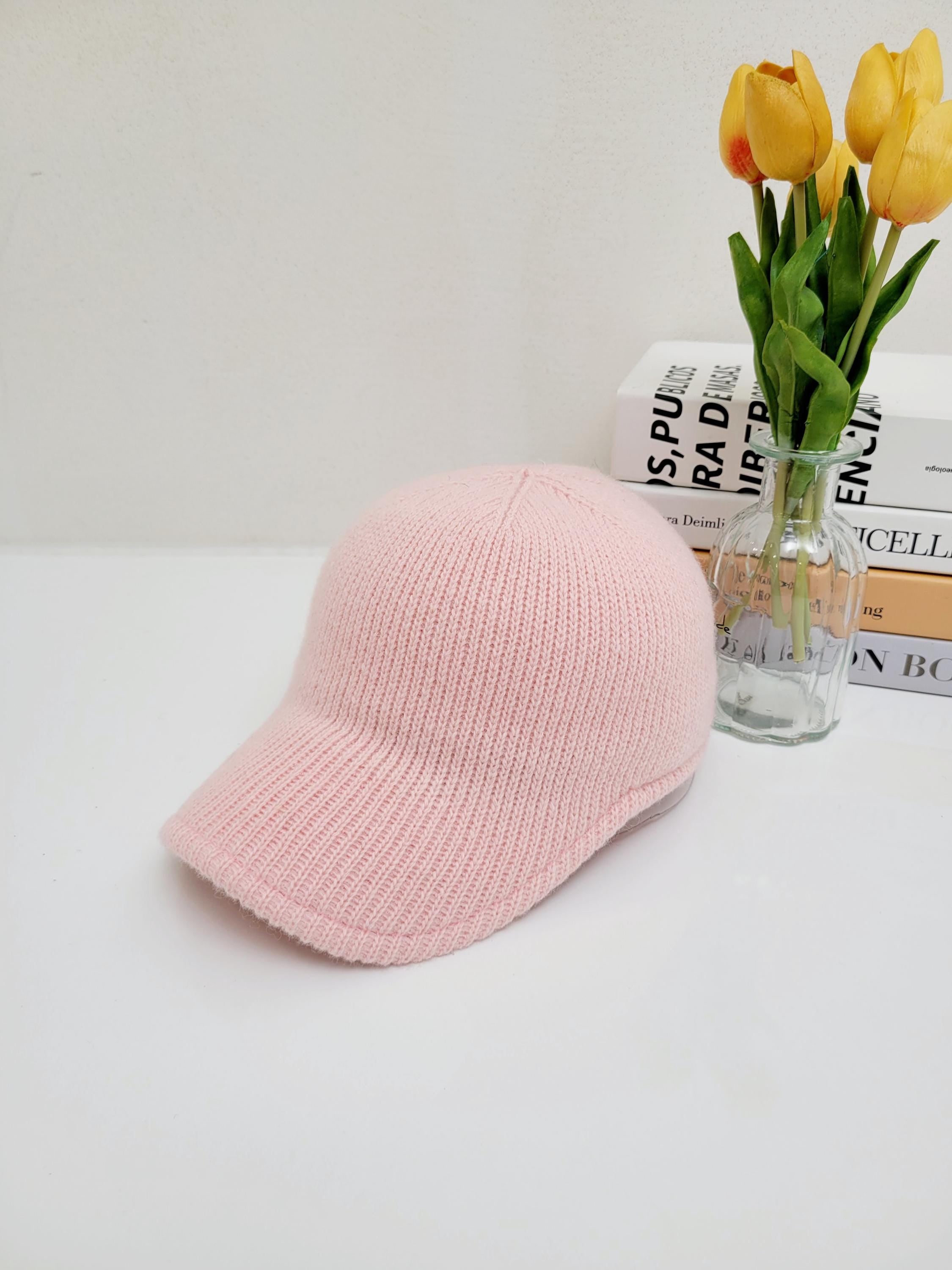 Light pink ribbed cap with a classic brim, knitted for a soft, comfortable fit