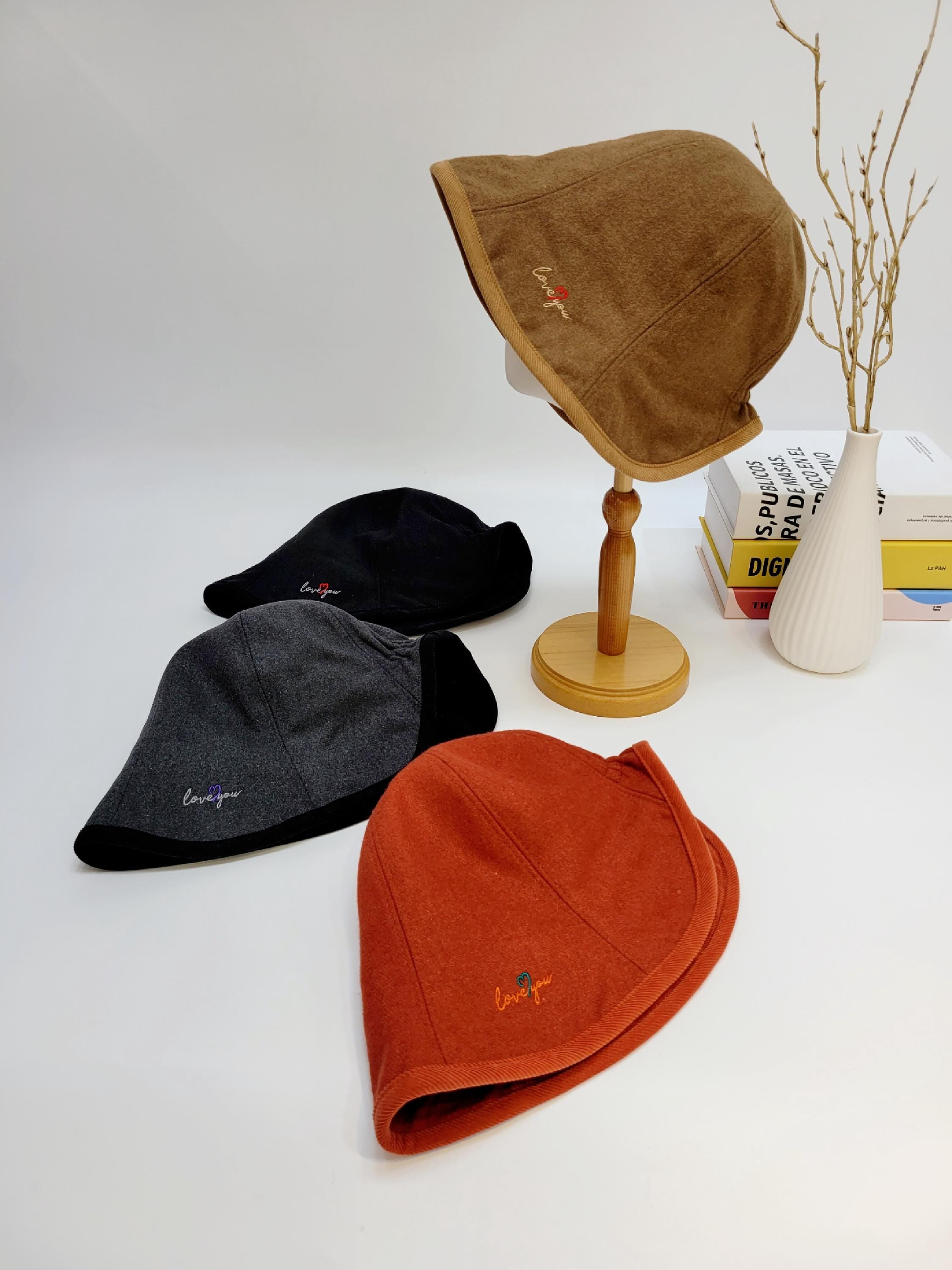Four wool hats in brown, black, gray, and orange, each embroidered with "love you". LOVE YOU - WOOL hats displayed.