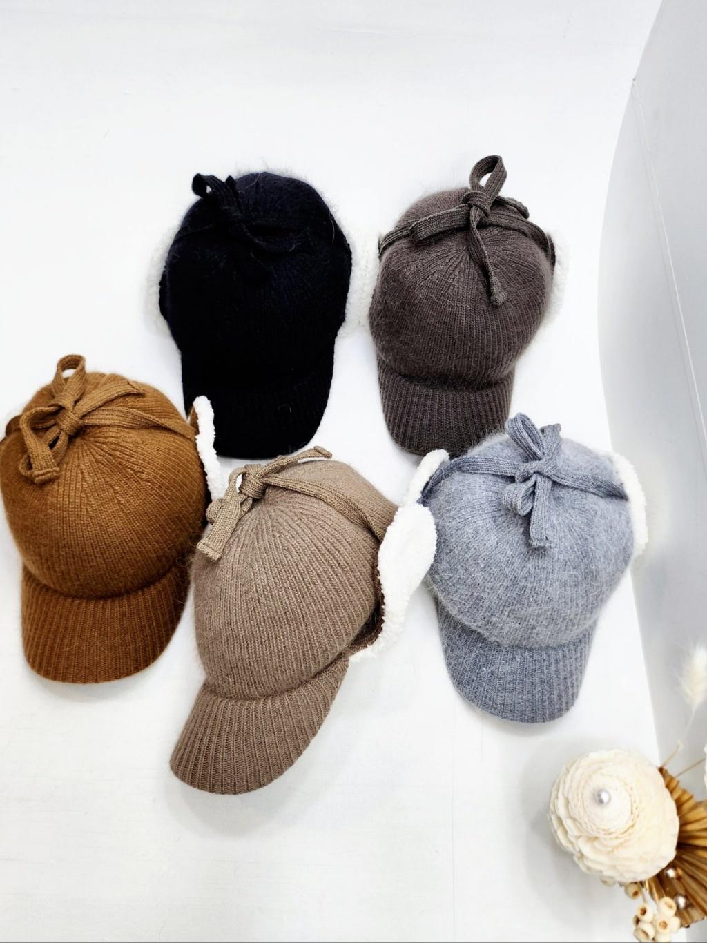 Angora trapper - earflap hats in black, brown, tan, taupe, and grey, featuring soft white faux fur ear flaps and charming tie closures