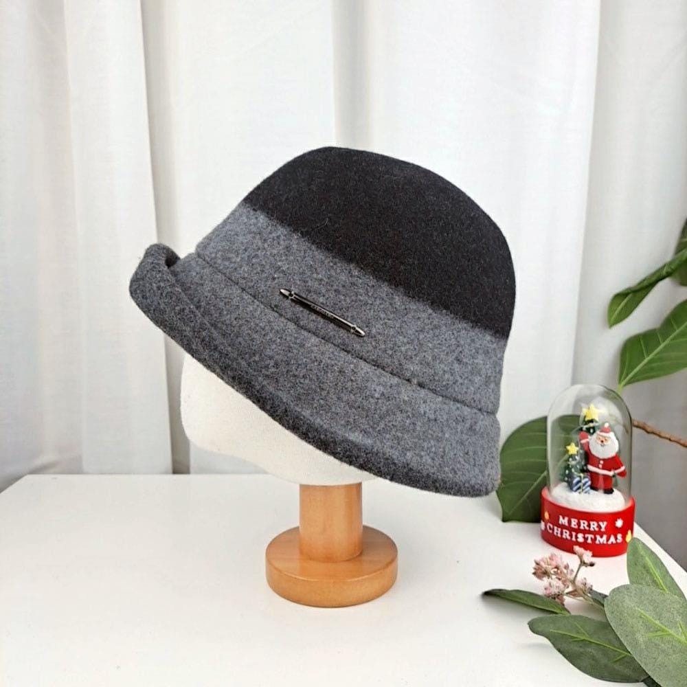 3tone wool bucket hat: stylish hat with dark gray crown, light gray band, and charcoal brim, displayed on a stand.