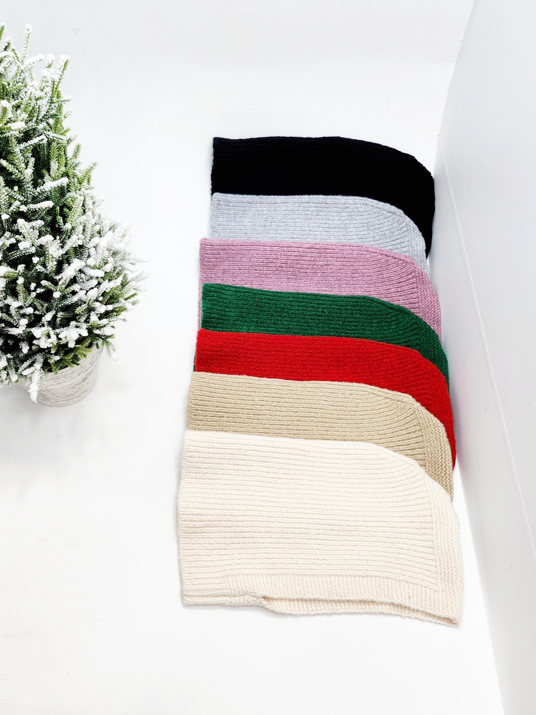 Stack of little riding hood - balaclavas in black, grey, lavender, green, red, beige, and cream knitted fabric