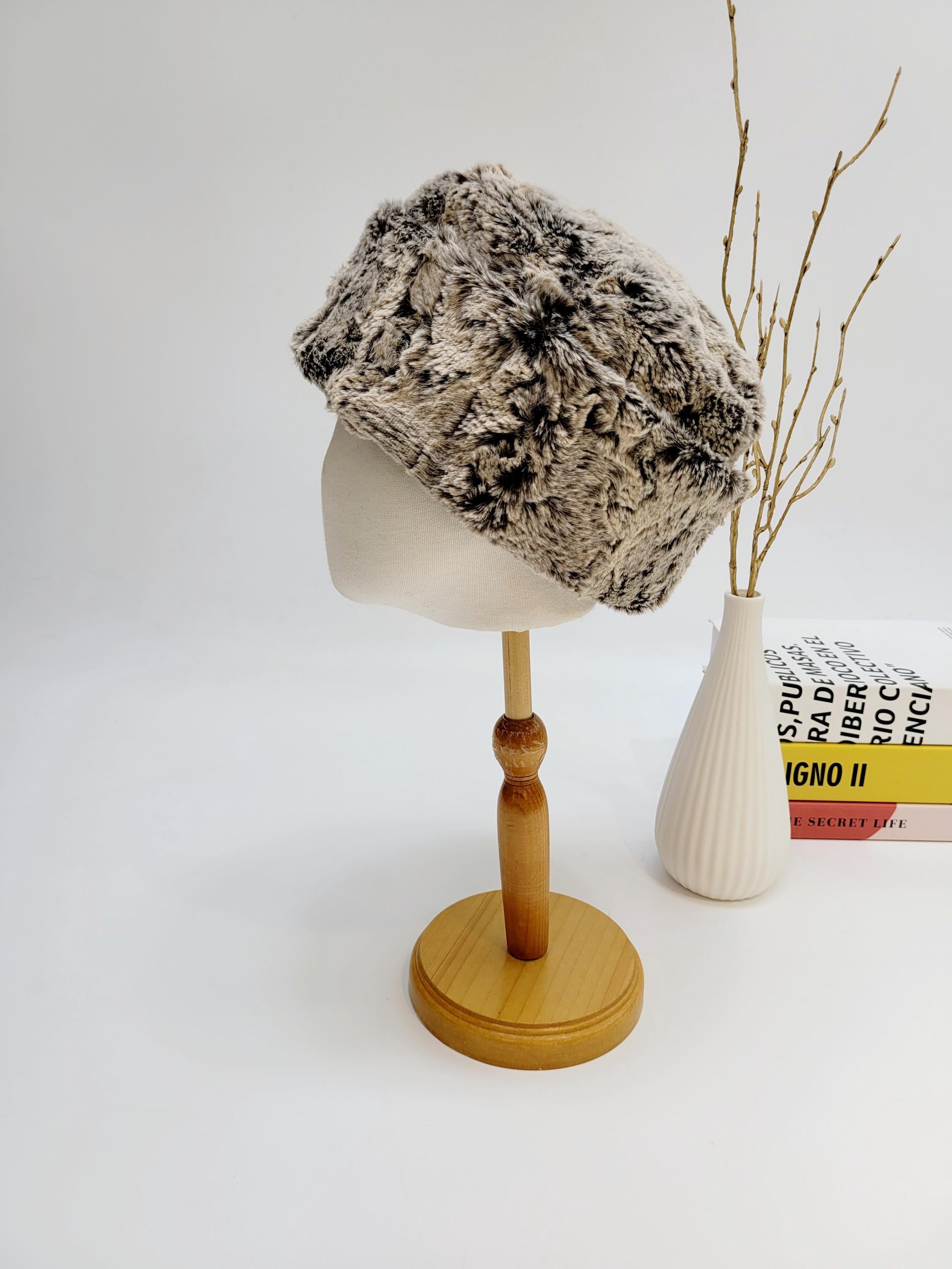 Faux fur russian hat in brown and black on a mannequin head, showcasing a stylish and warm winter accessory.