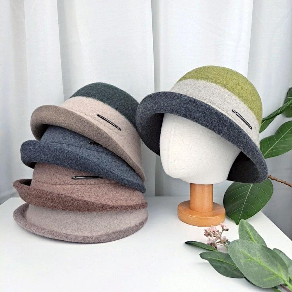 Stack of 3tone wool bucket hat in grey, brown, green hues; one displayed on a mannequin head. Stylish fall/winter headwear.