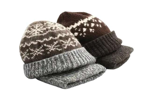 Two knitted winter hats with snowflake patterns, one grey and one brown.
